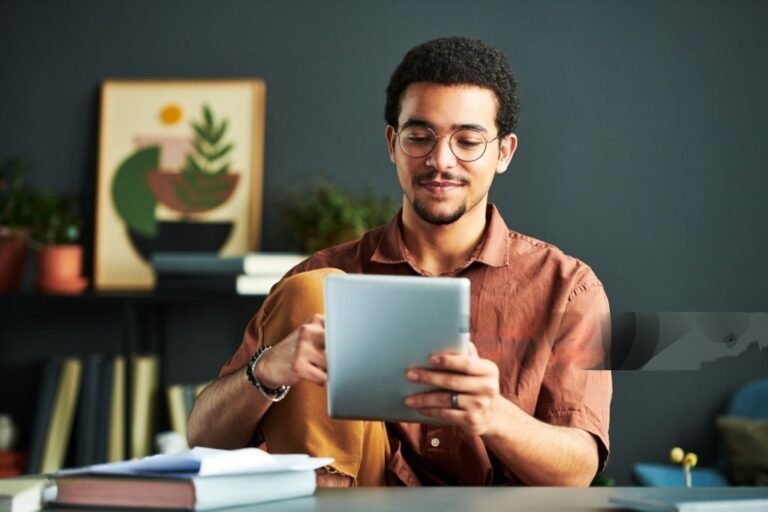 An individual examining web-based entertainment information on a PC